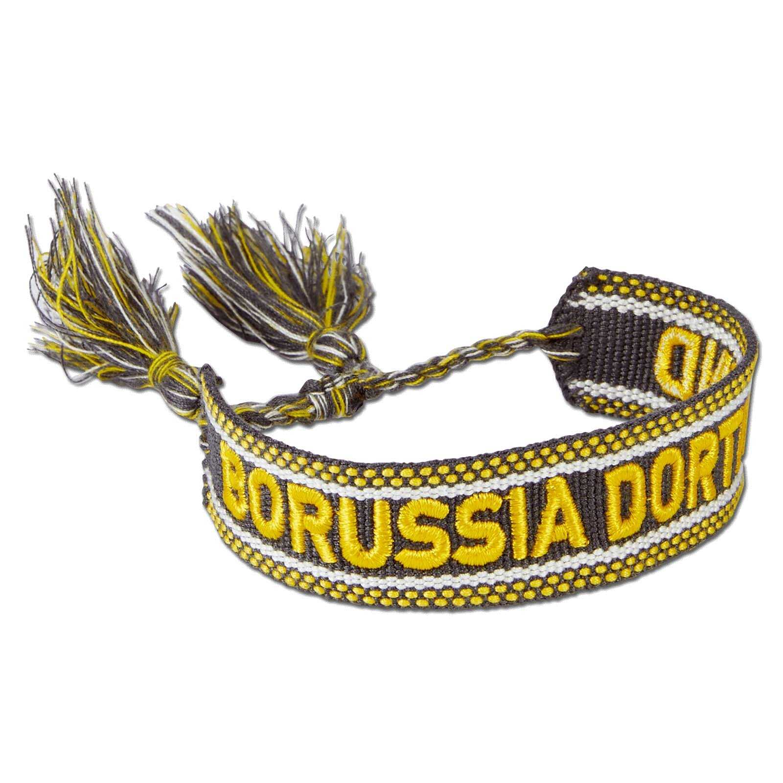 Detailansicht des BVB Stoffarmbands in schwarzgelb mit eingewebtem "Borussia Dortmund"-Schriftzug und geflochtenen Enden mit Quasten.